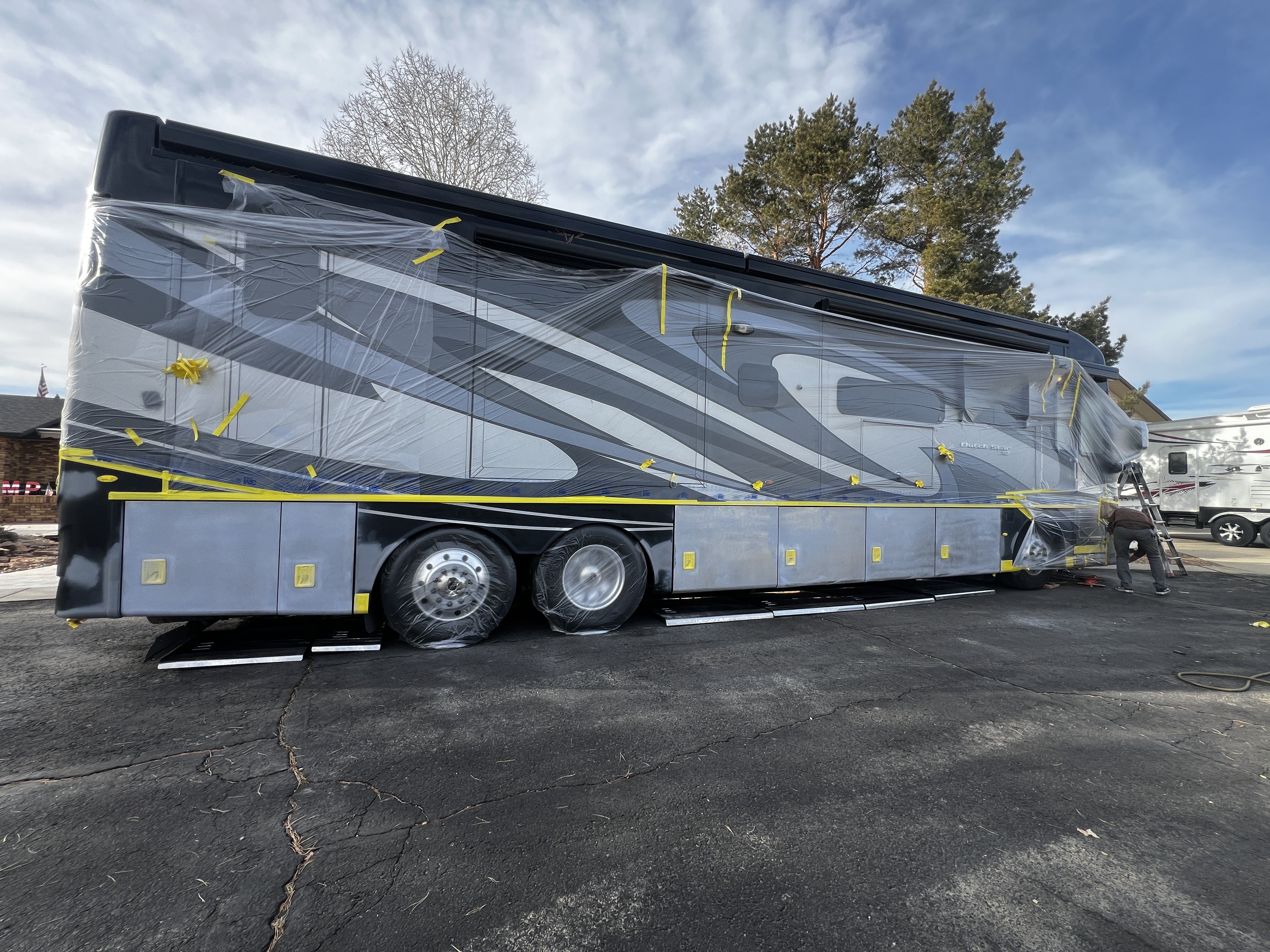 Large Class A motorhome fully masked for paint restoration